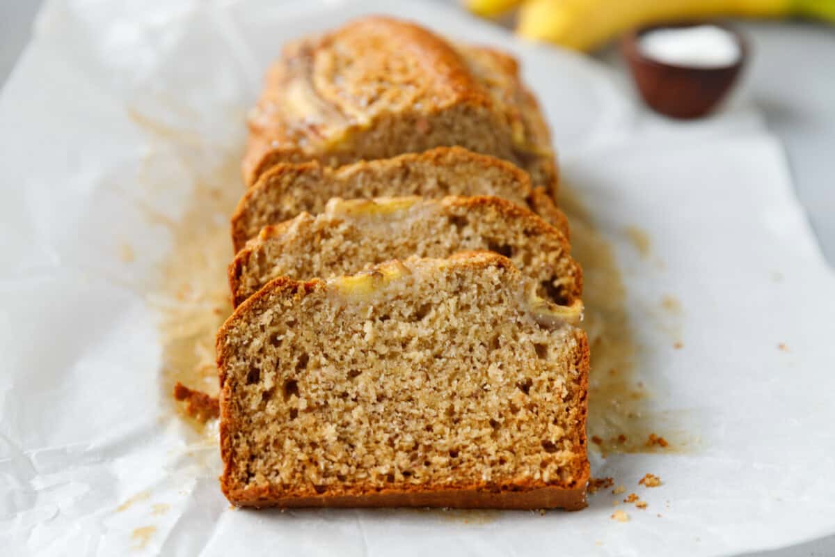 Slices of banana coconut bread on white parchment paper