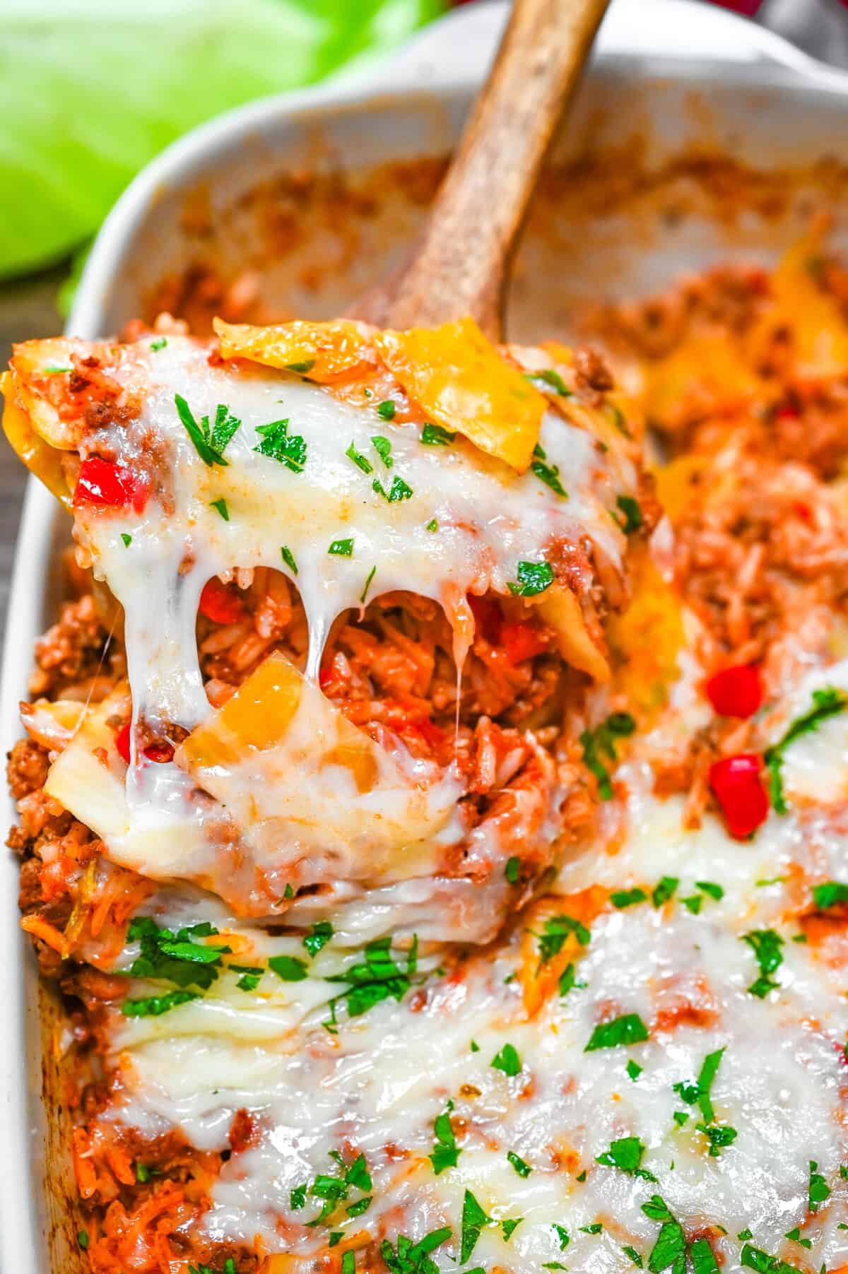 Lazy Cabbage Roll Casserole topped with cheese on a wooden serving spoon