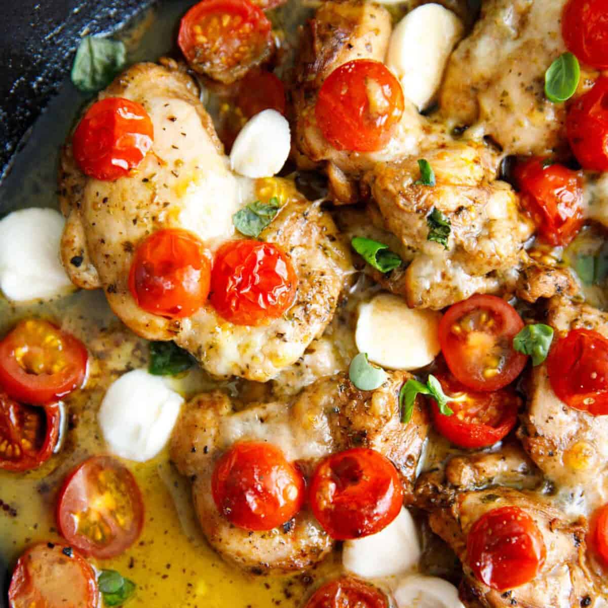 Caprese chicken thighs in a skillet