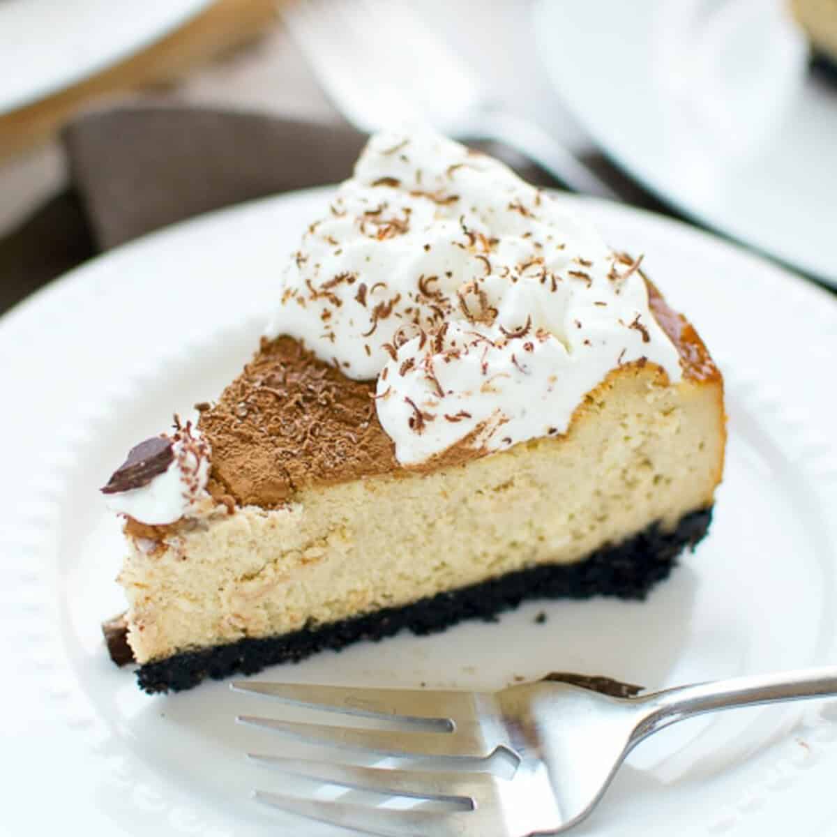 Tiramisu Cheesecake slice on a white plate