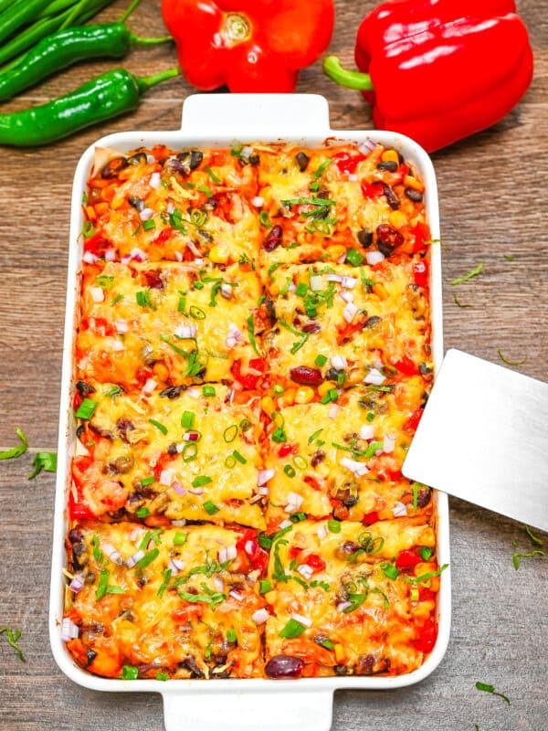A white ceramic baking dish with Enchilada Casserole