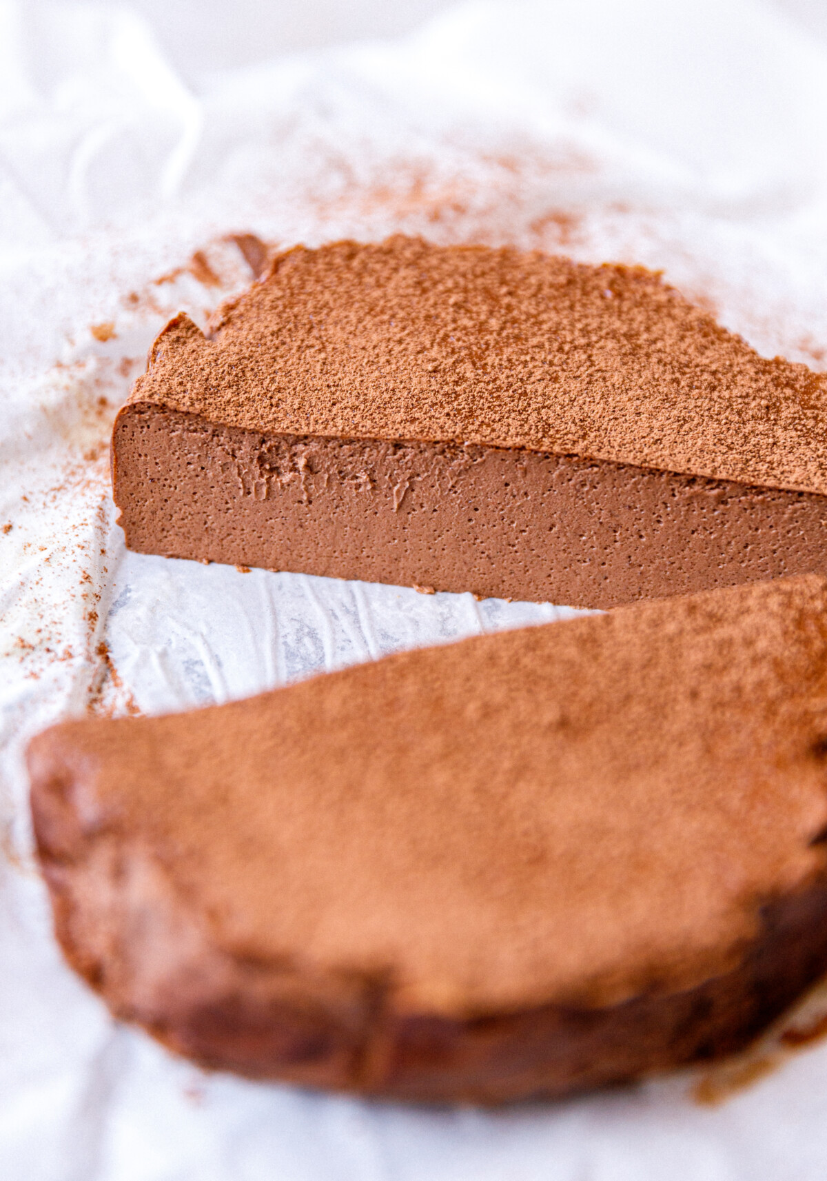 Cottage chocolate mousse cheesecake on parchment paper cut in half.