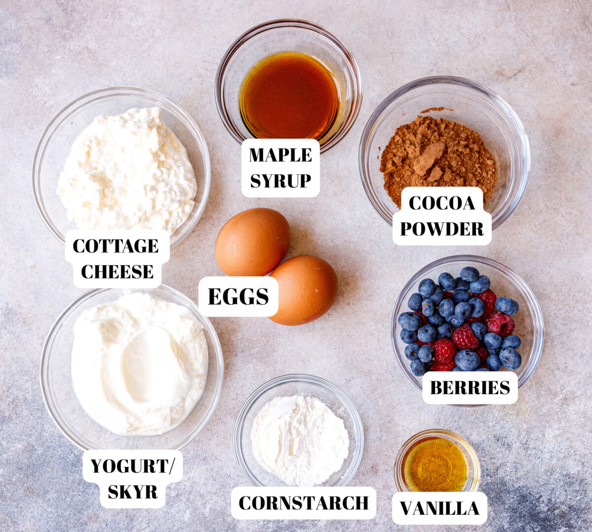 Clear glass bowls with ingredients for chocolate cottage cheese cheesecake