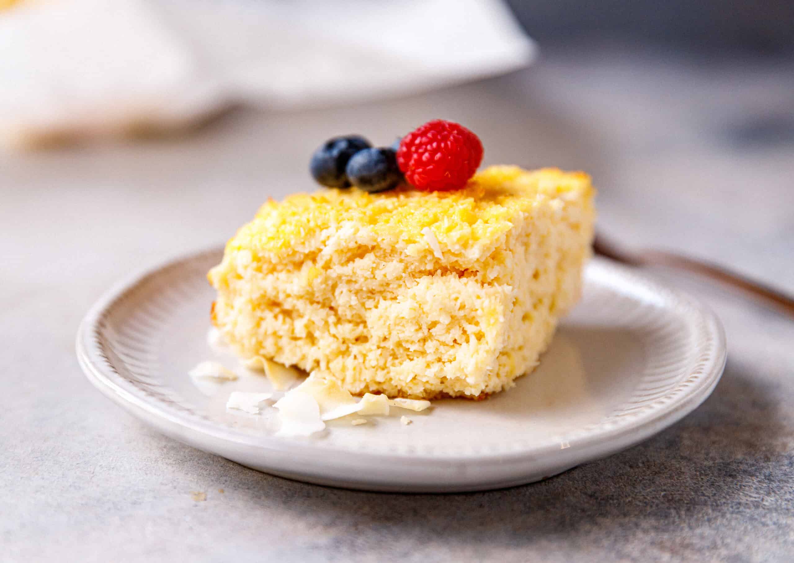 Coconut yogurt cake batter mixed in a large mixing bowl, ready to be transferred to a cake pan.