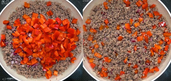 A pan on a stove top with cooked ground beef and red peppers