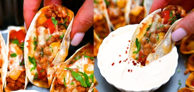 Close-up of baked mini tacos being picked up and dipped into sour cream.