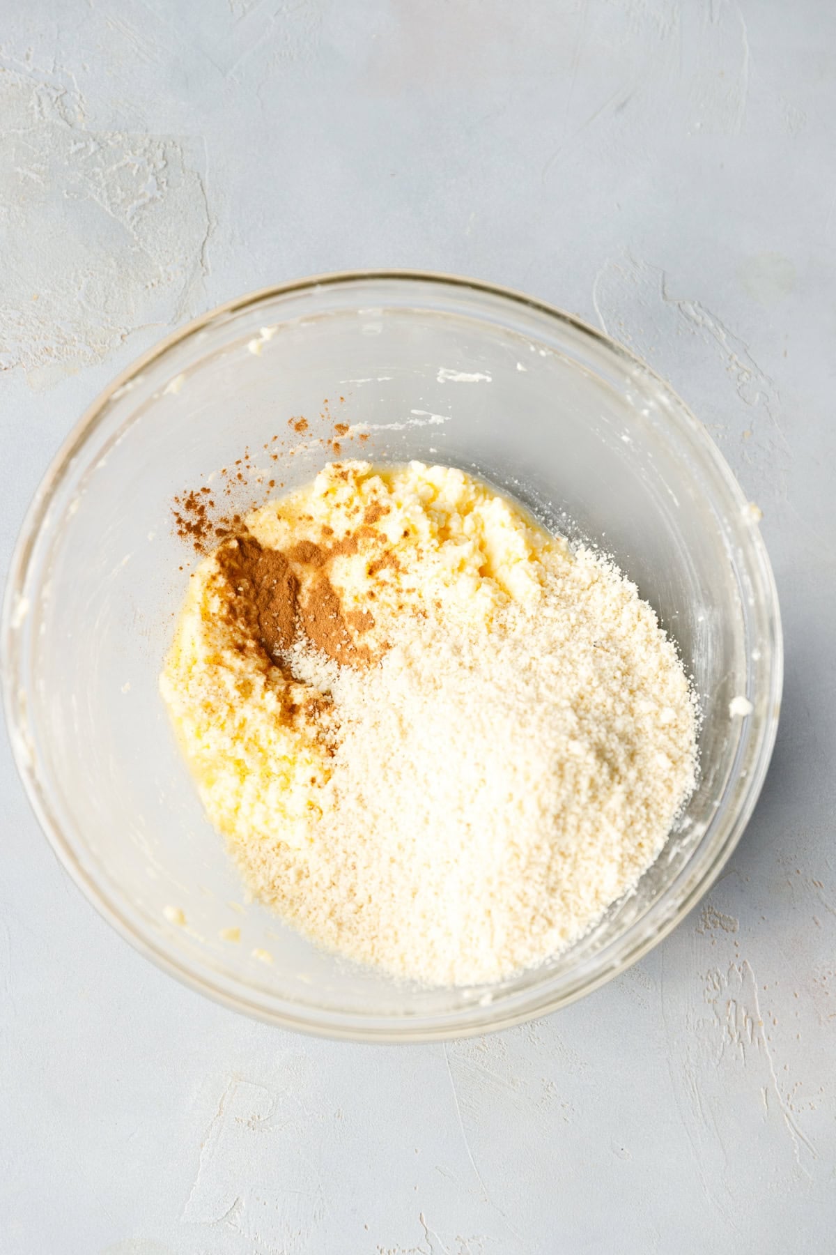 Almond flour poured into the cinnamon butter mixture to form the cookie dough.