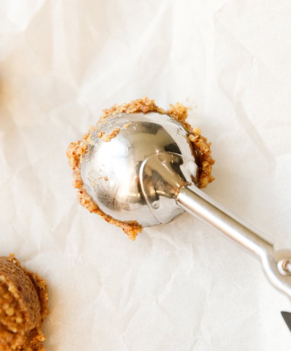 Cookie scoop forming uniform scoops of maple pecan cookie dough
