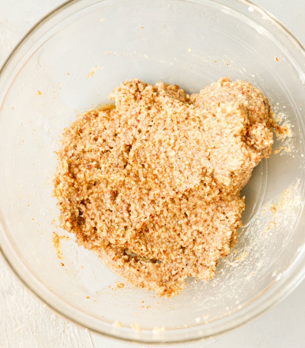 Soft maple pecan cookie dough mixed together in a glass bowl