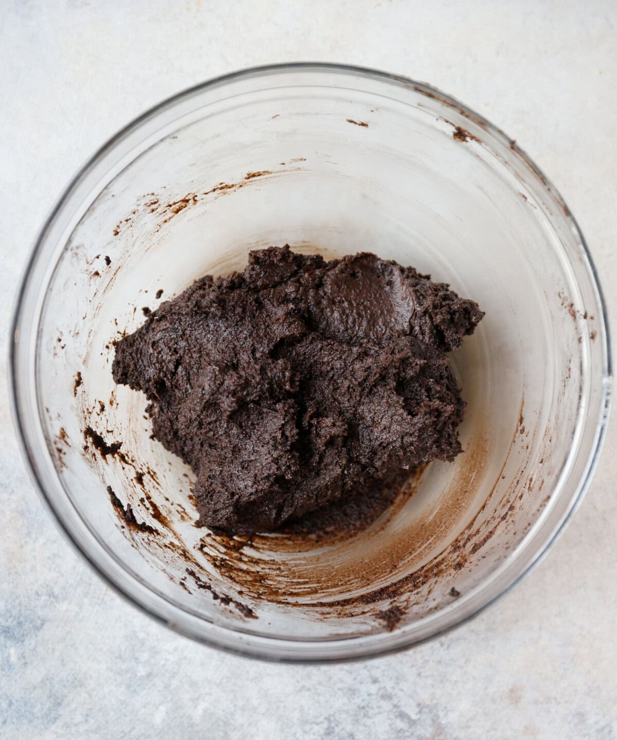 Oreo crumb and cream cheese mixture mixed into a thick dough in a glass bowl