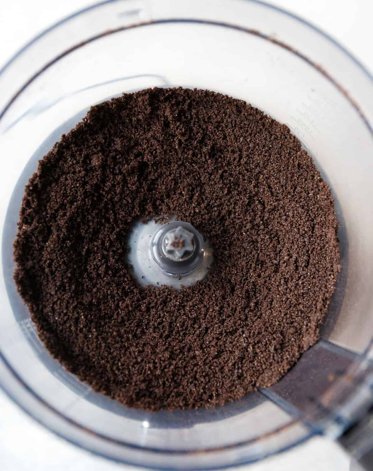 Oreo cookies crushed into fine crumbs in a food processor