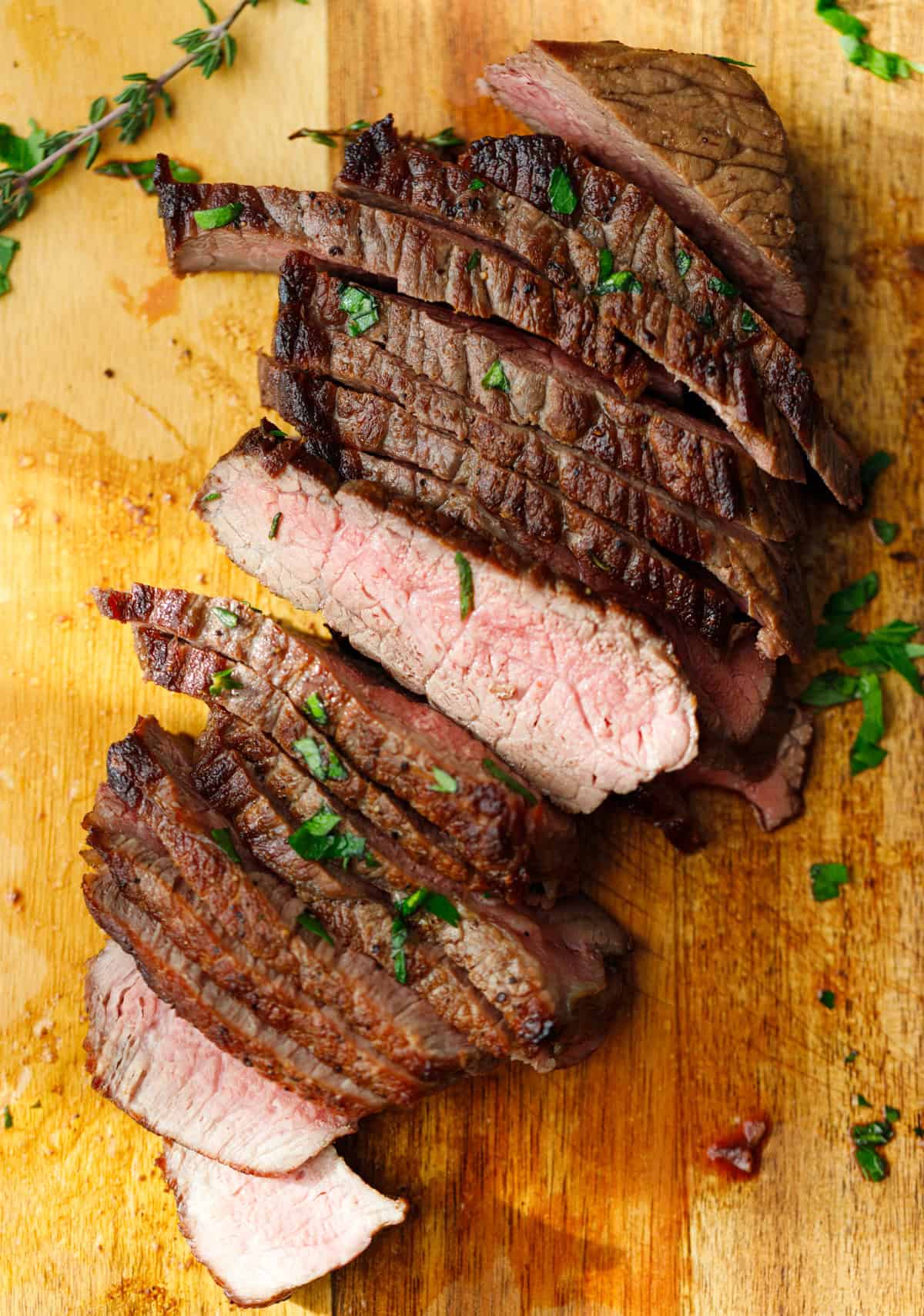 Close-up of sliced Denver steak with pink center and crispy crust.