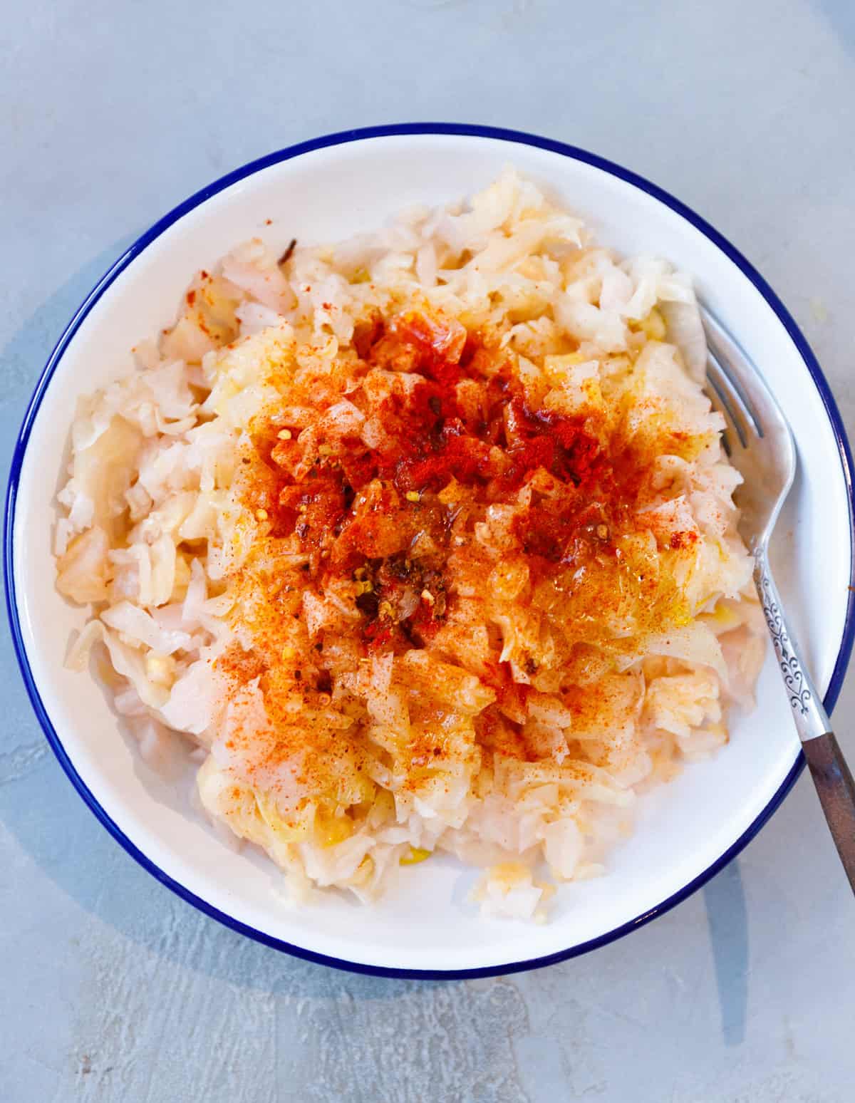 Traditional sauerkraut salad made with fermented cabbage and paprika in a bowl