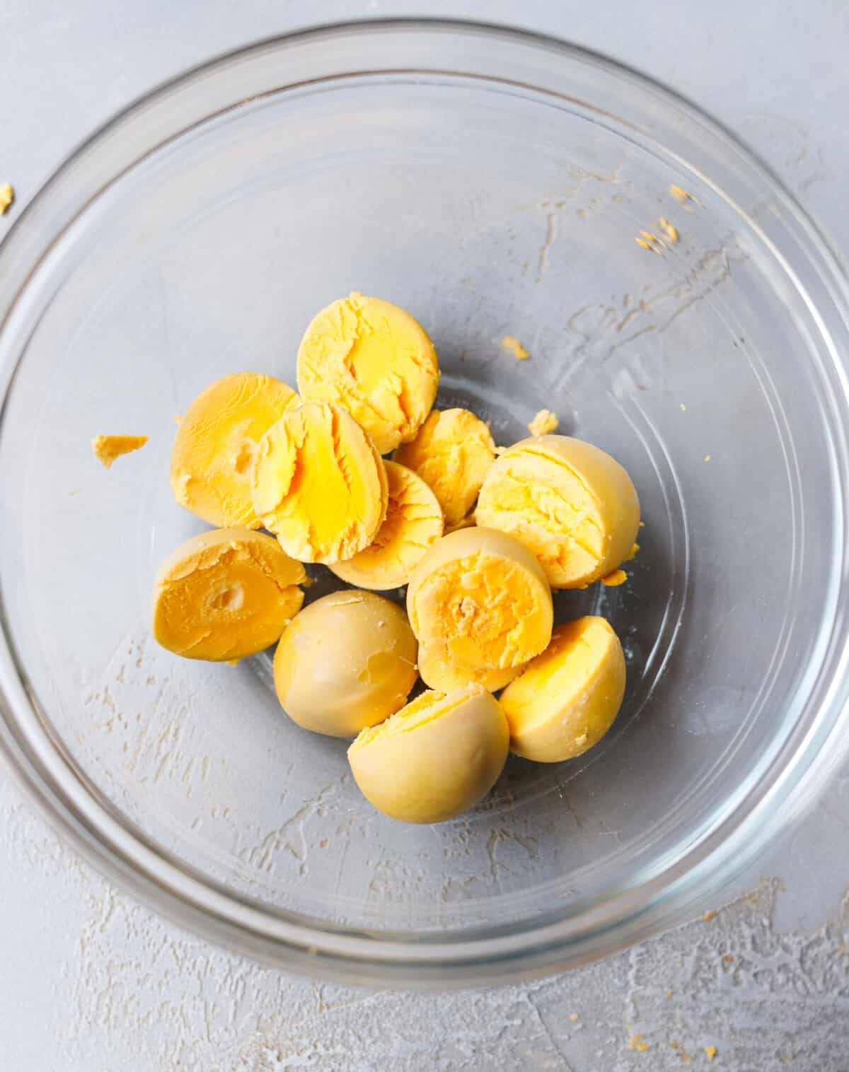 Hard boiled egg yolks separated in glass bowl for deviled eggs