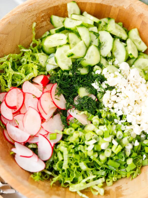 Fresh vegetables for Mediterranean lettuce salad with cucumber radishes dill and feta