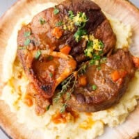 Braised beef shanks osso buco with tomato sauce served on mashed potatoes