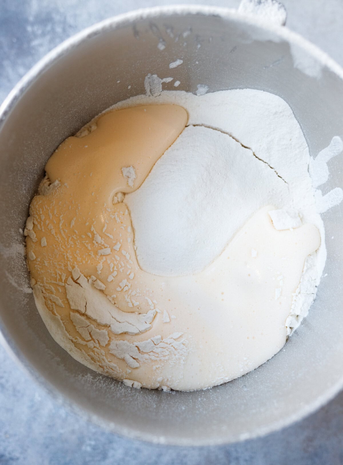 mixing flour with egg and yeast mixture to form kulich dough