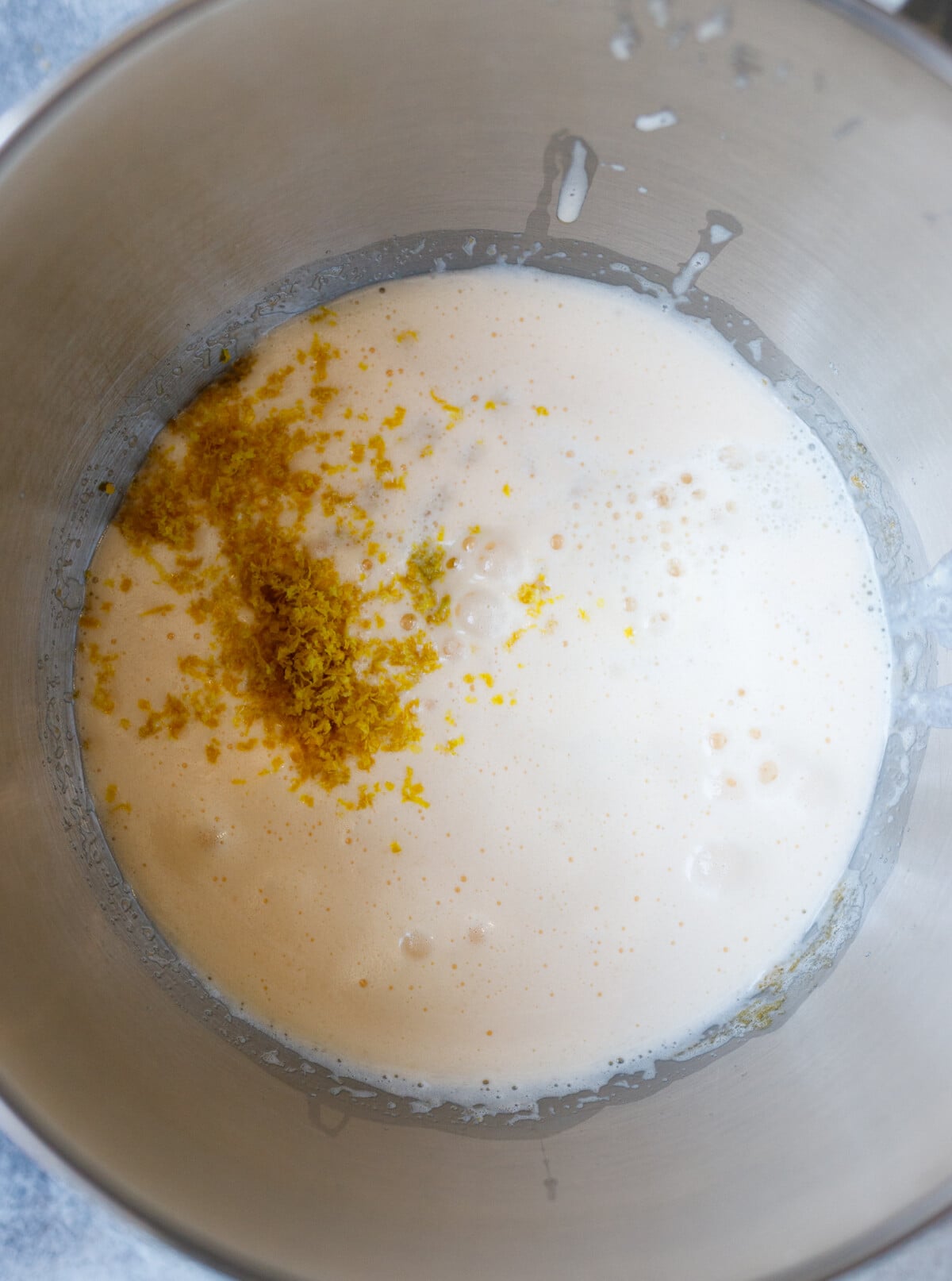 adding lemon and orange zest to kulich dough mixture