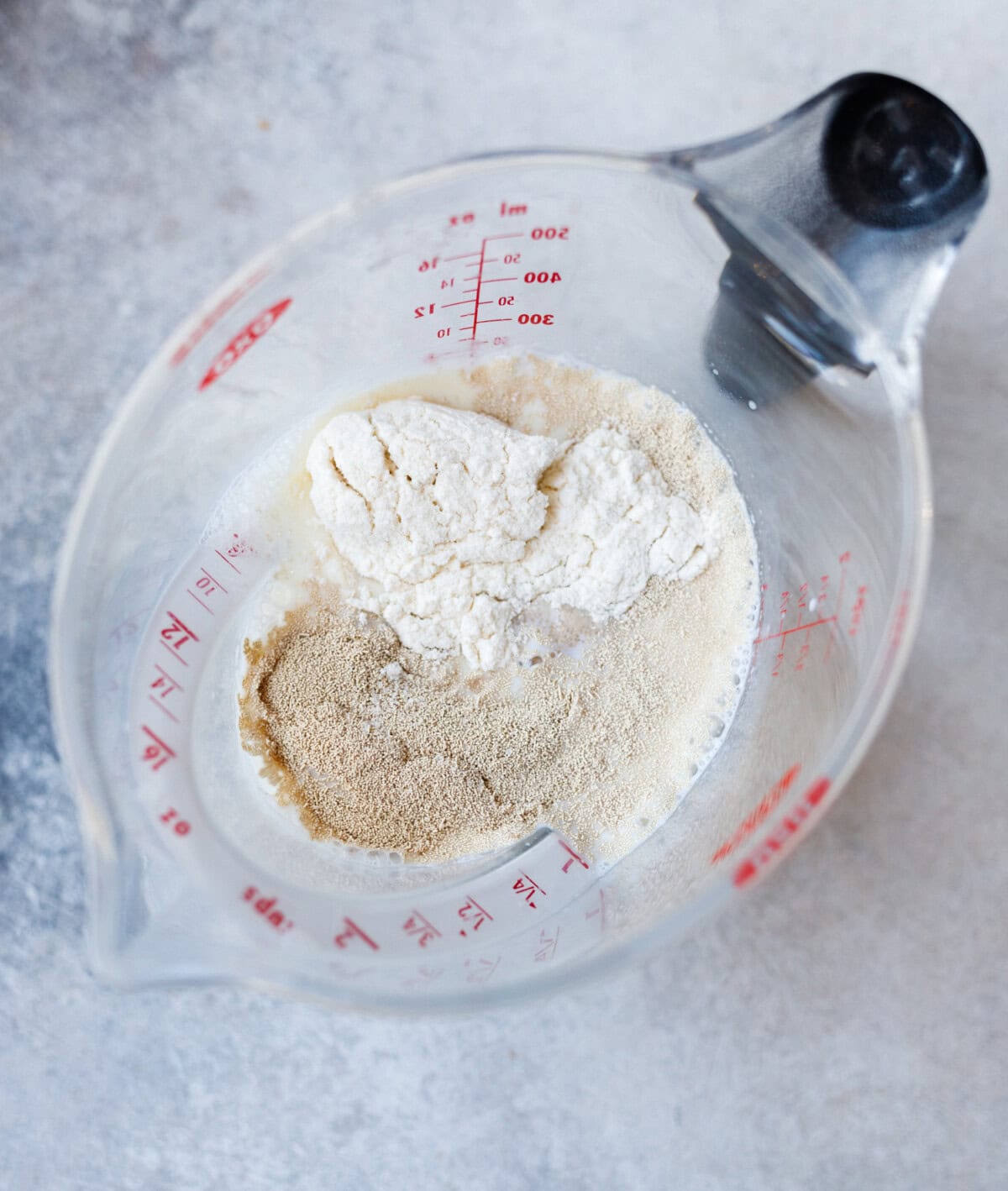 activating yeast in warm milk with sugar and flour for kulich dough