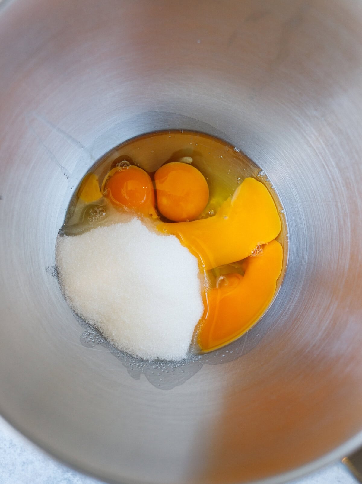 eggs and sugar in bowl before whipping for enriched kulich dough