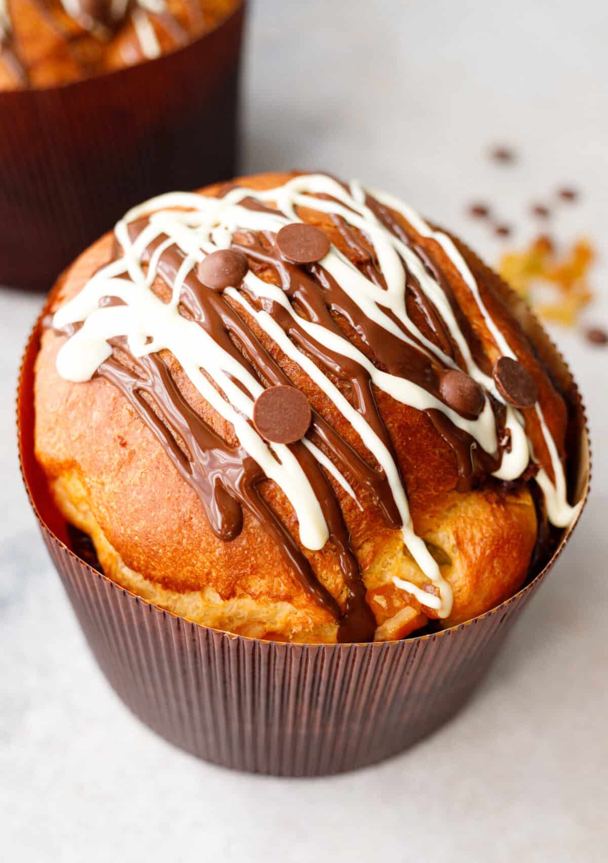 kulich easter bread baked in paper mold with chocolate drizzle on top