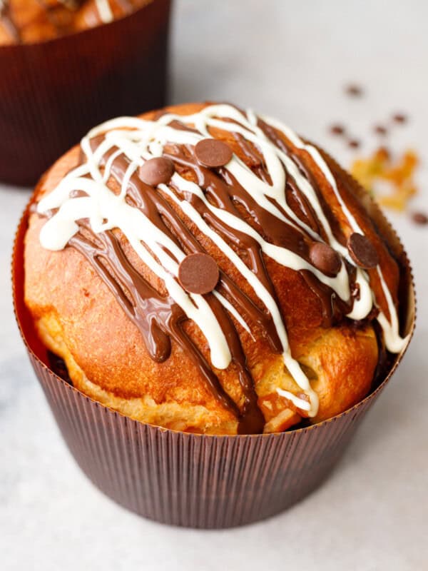 kulich easter bread baked in paper mold with chocolate drizzle on top
