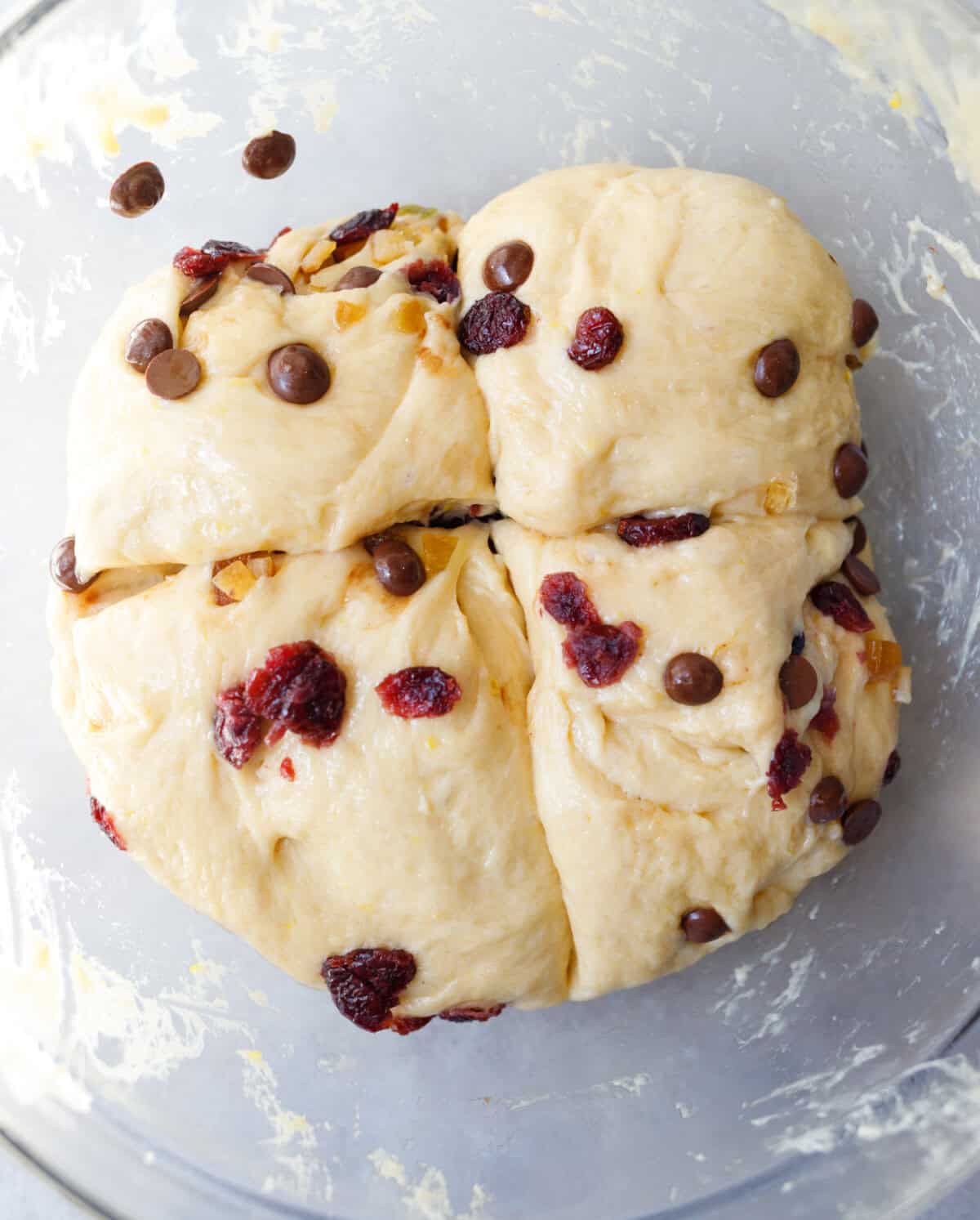 kulich dough divided into portions after adding dried fruit and chocolate