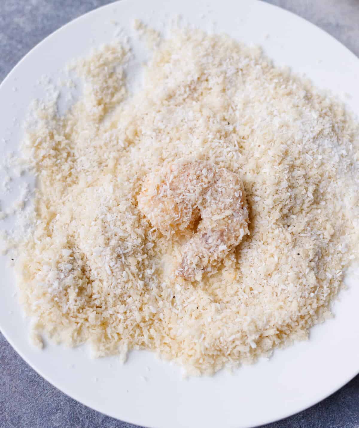 Shrimp coated in coconut and panko mixture before frying