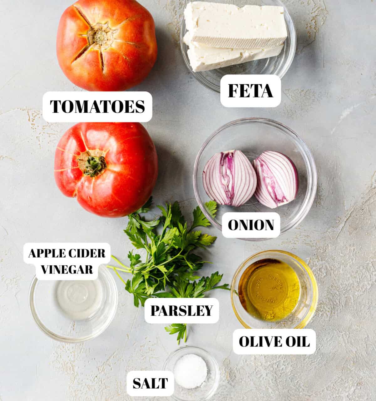 Ingredients for Bulgarian tomato salad — ripe tomatoes, feta, red onion, parsley, olive oil, apple cider vinegar, and salt