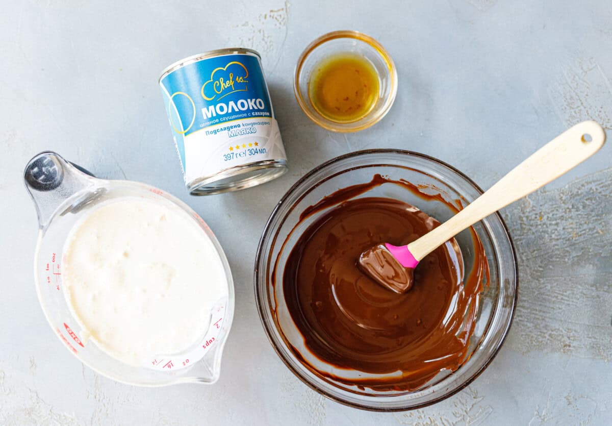 Ingredients for chocolate condensed milk ice cream — heavy cream, condensed milk, vanilla, and melted chocolate