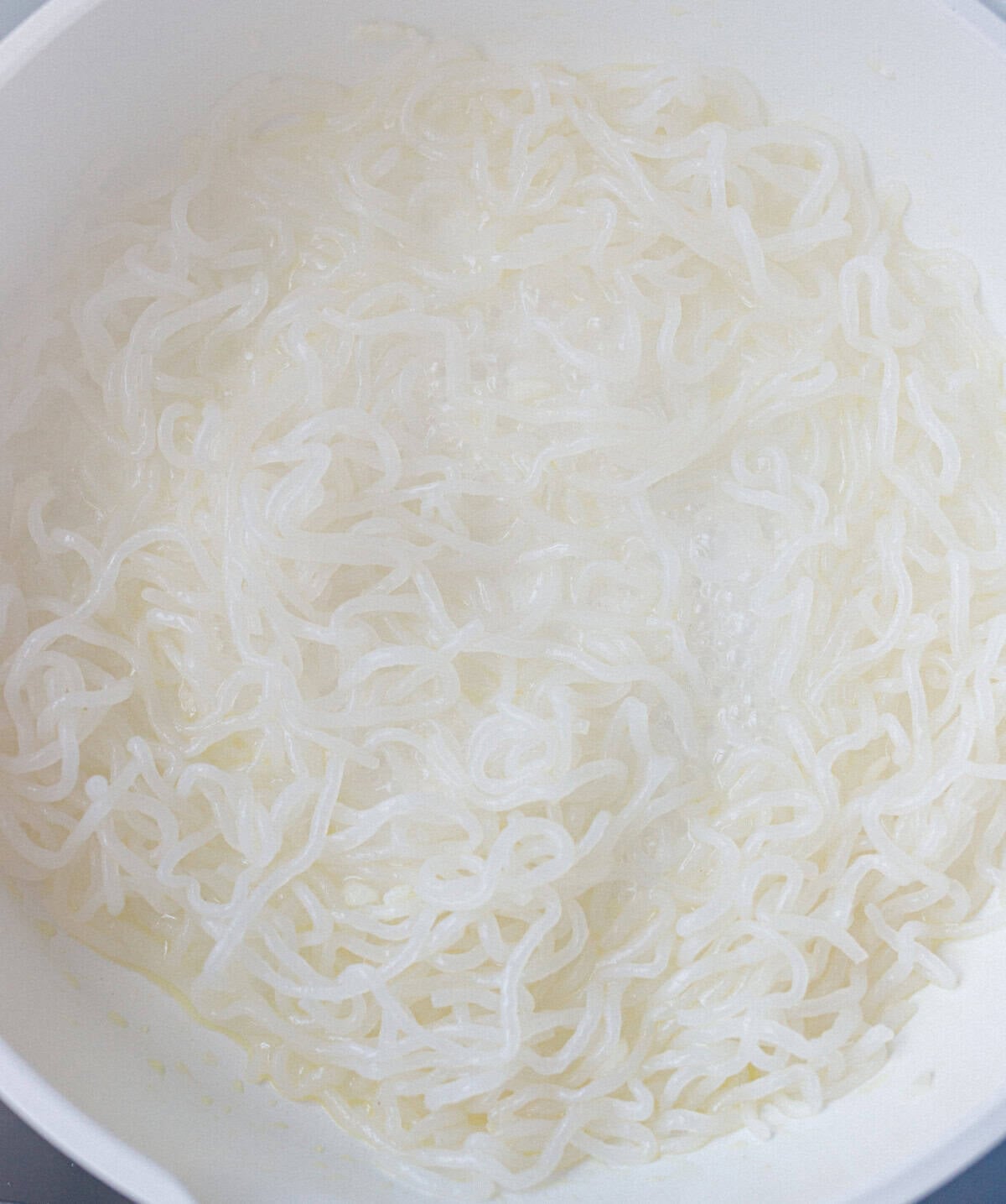 Rinsed and drained konjac noodles in a pan, the first step of konjac carbonara