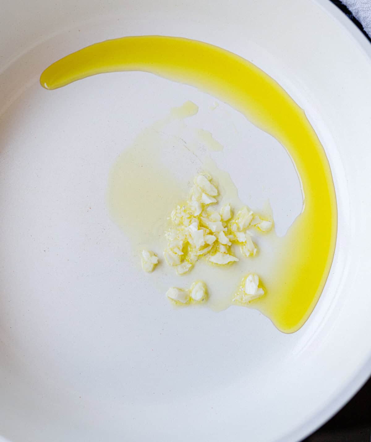 Minced garlic cooking in olive oil at the start of konjac carbonara
