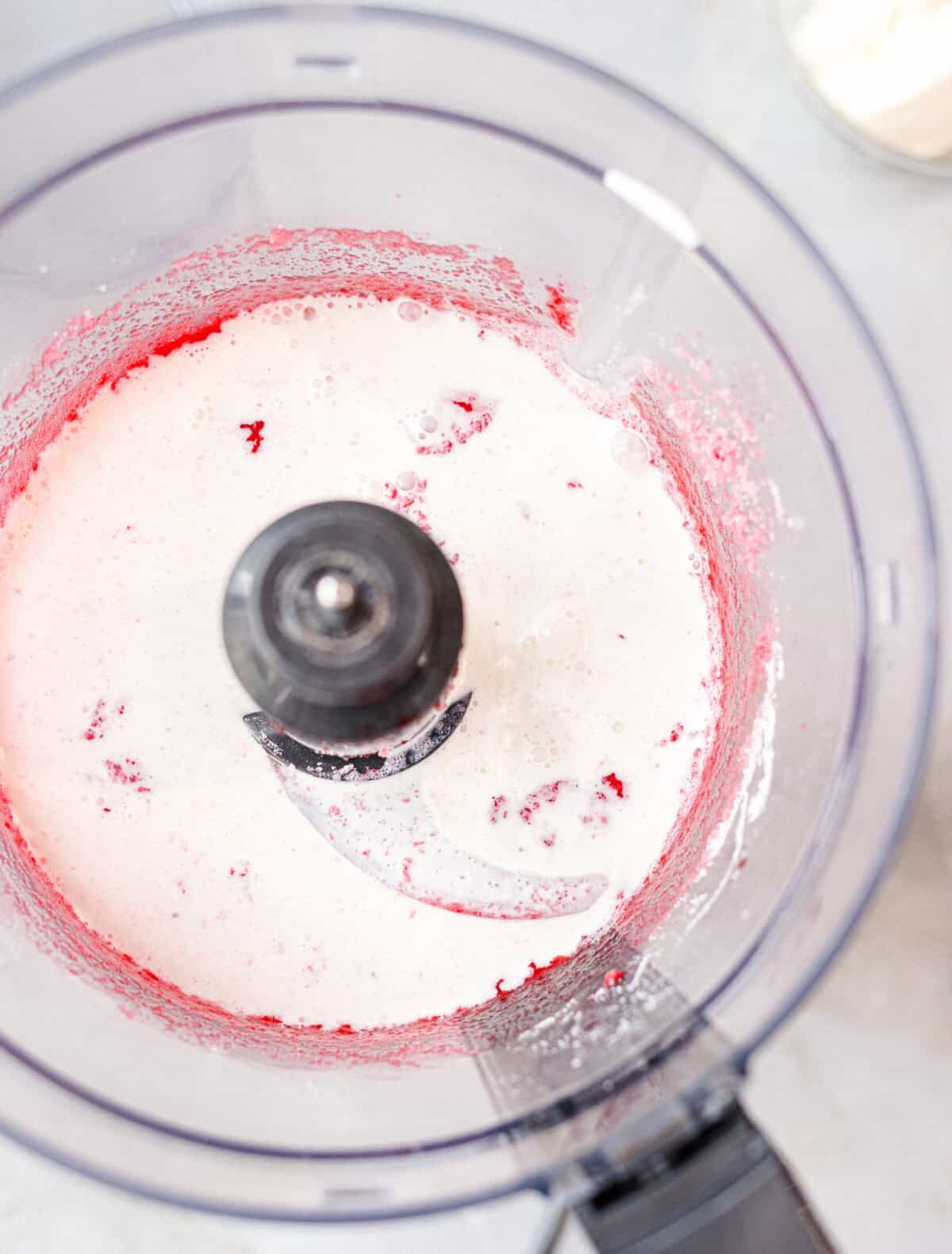 Raspberries and heavy cream blended smooth in a food processor for low-carb ice cream
