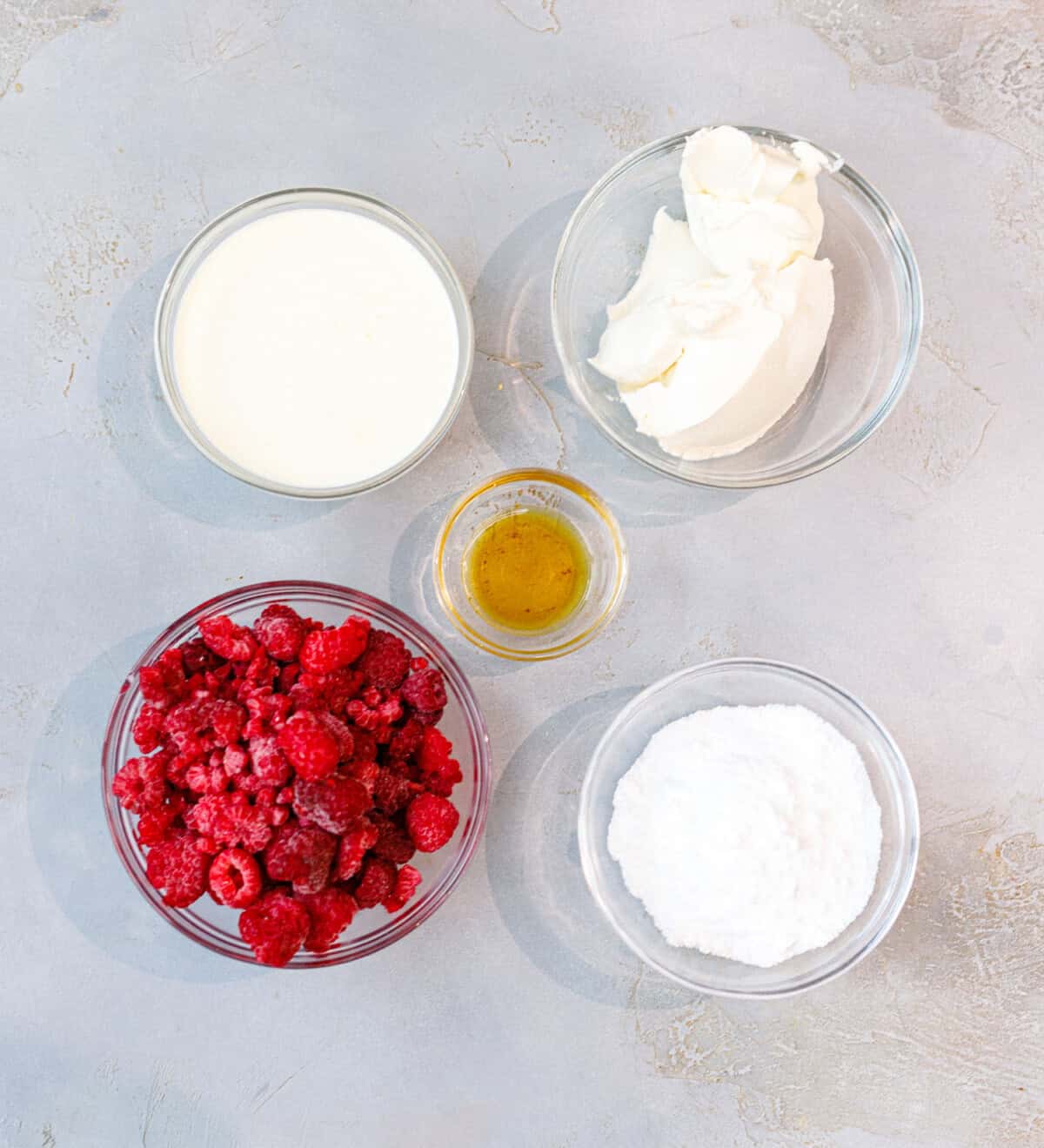 Ingredients for low-carb raspberry mascarpone ice cream — mascarpone, heavy cream, raspberries, vanilla, and powdered sweetener