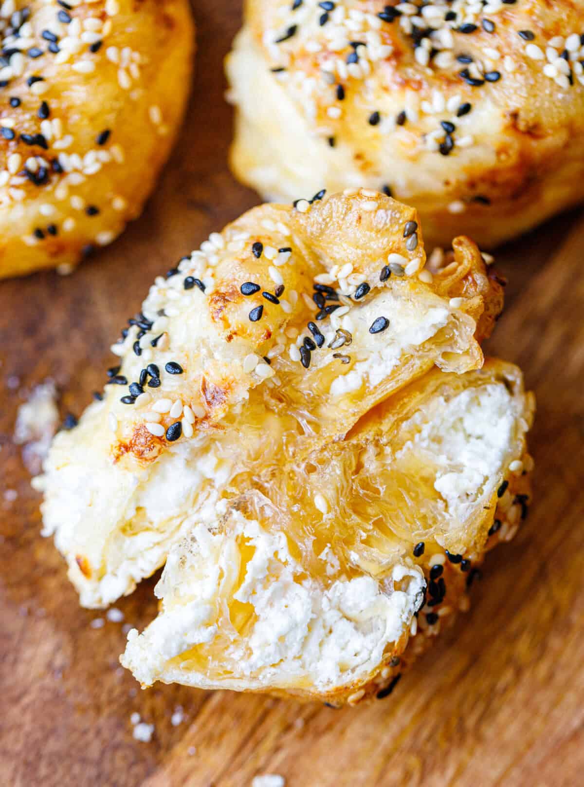 Rice paper banitsa torn open to show the melted white cheese filling inside