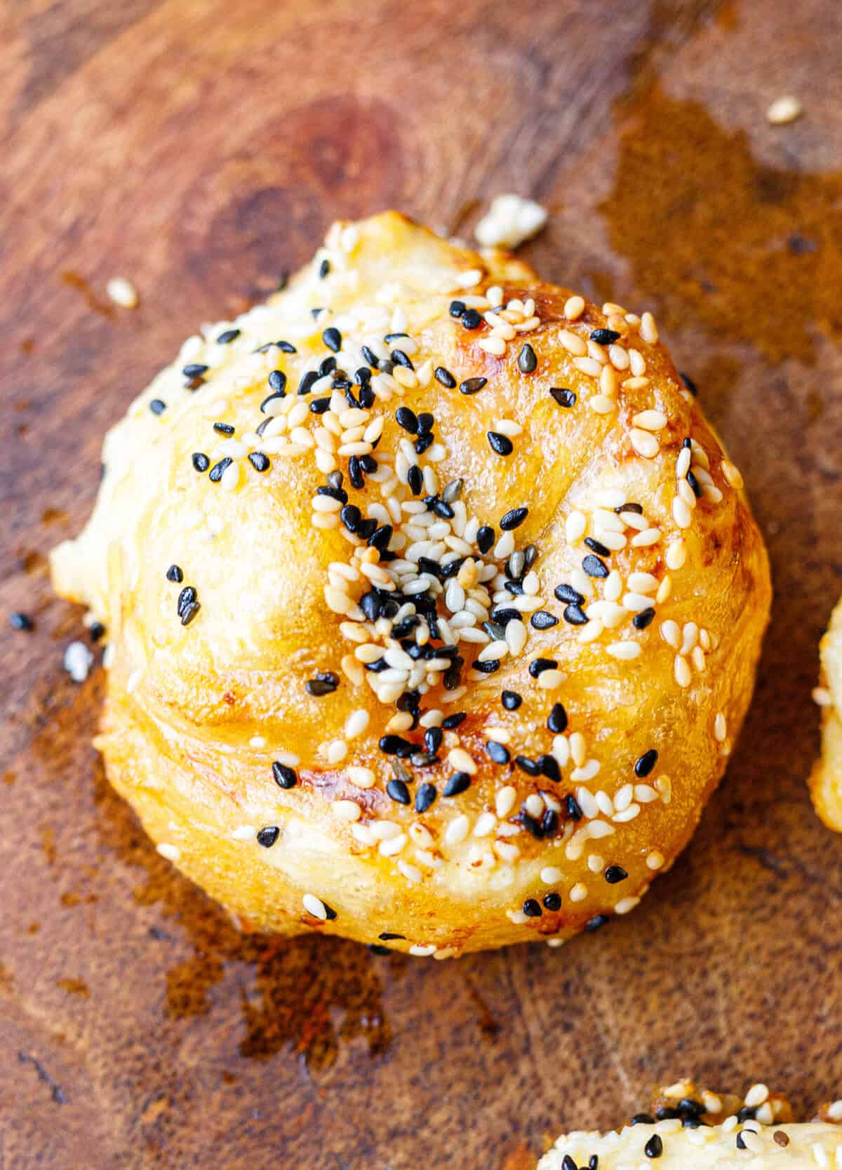 Close-up of a golden air fryer banitsa topped with toasted sesame seeds