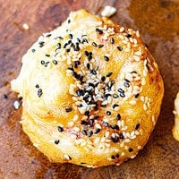 Close-up of a golden air fryer banitsa topped with toasted sesame seeds