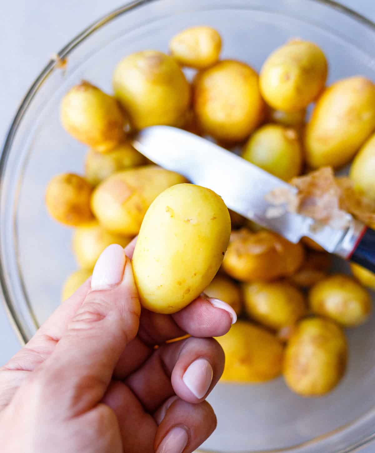 Fresh small new potatoes in a glass bowl, ready to make sautéed potatoes