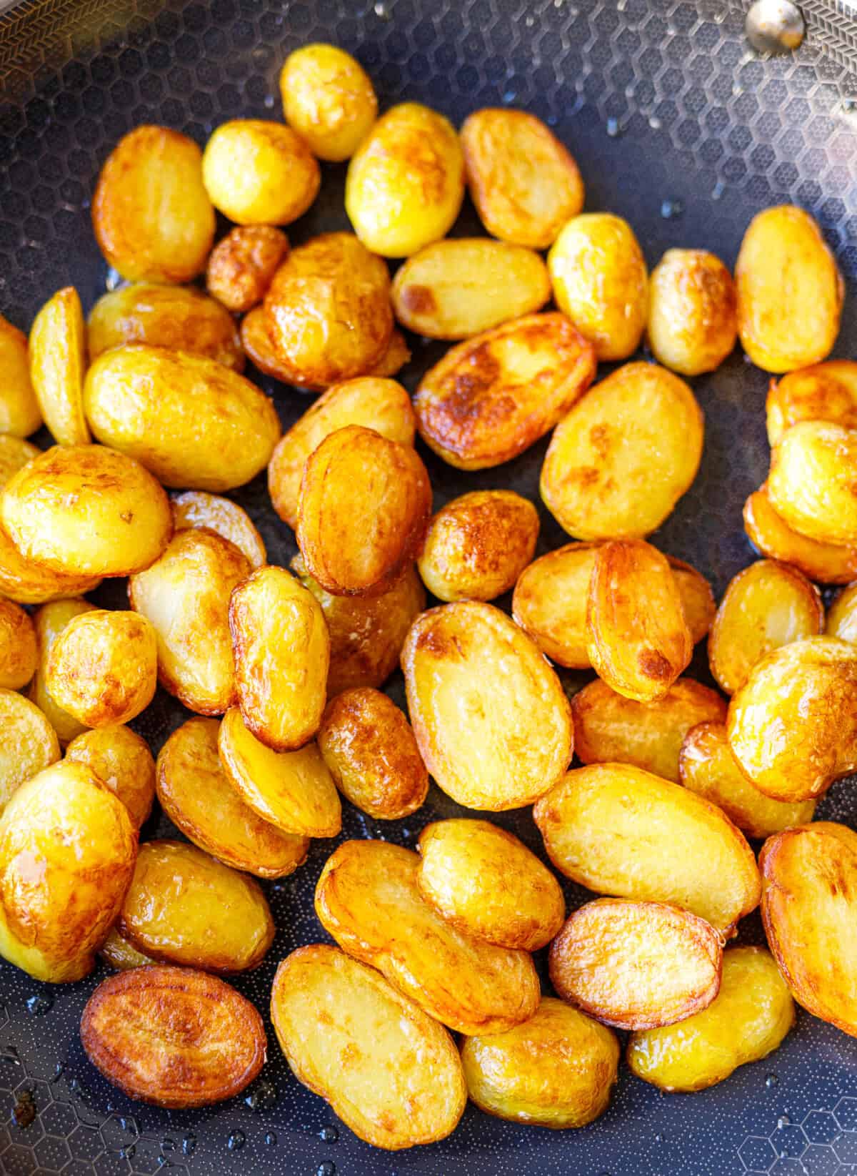 Golden, crispy sautéed potatoes browning in a skillet