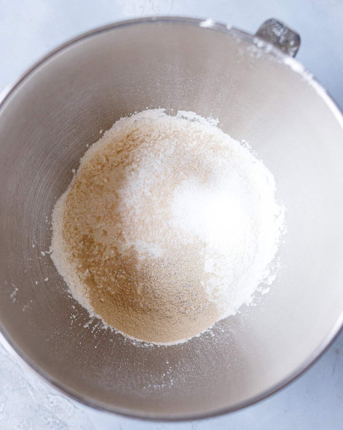 Bread flour, sugar, salt, and yeast in a stand mixer bowl