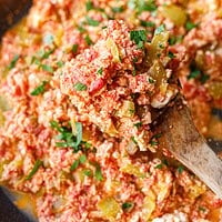 Close-up of Bulgarian mish mash showing soft eggs, green peppers and crumbled feta