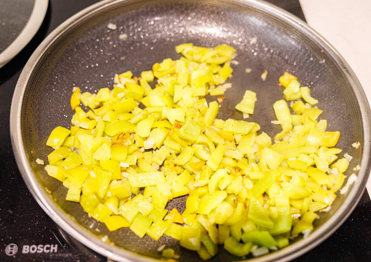 Green peppers softened and turning golden in a skillet