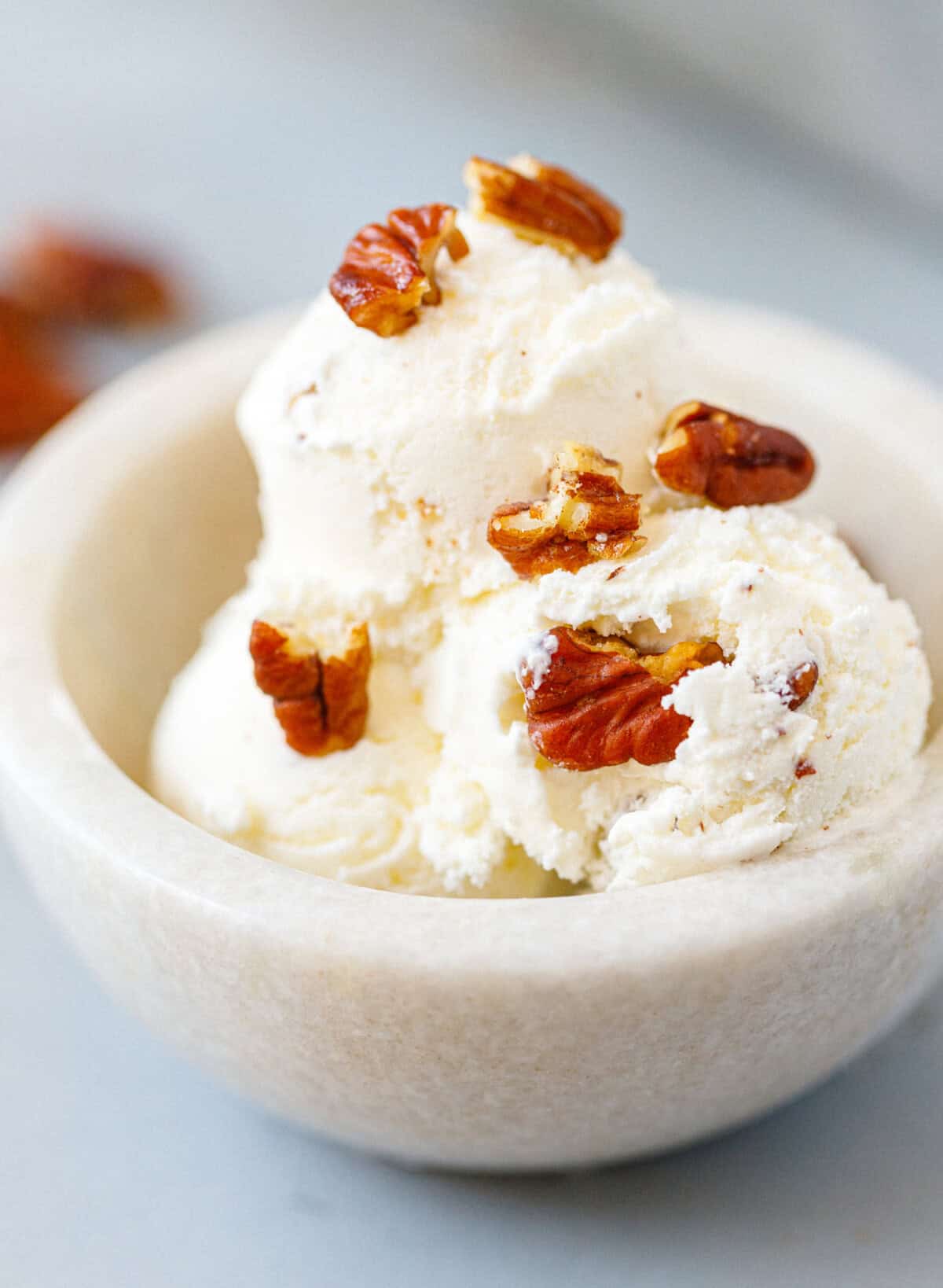 Creamy homemade butter pecan ice cream served in a bowl with buttery toasted pecans.