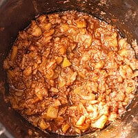Soft cooked apples with cinnamon in a slow cooker for crockpot applesauce