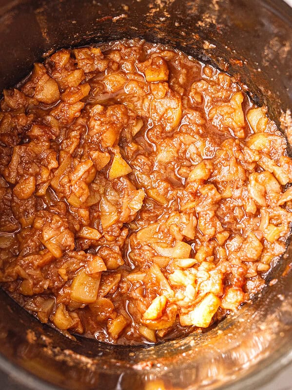 Soft cooked apples with cinnamon in a slow cooker for crockpot applesauce