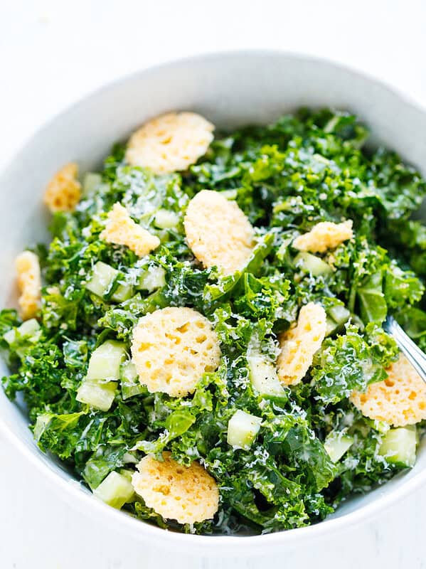 Close-up of kale Caesar salad with crispy Parmesan crisps, cucumber and grated Parmesan